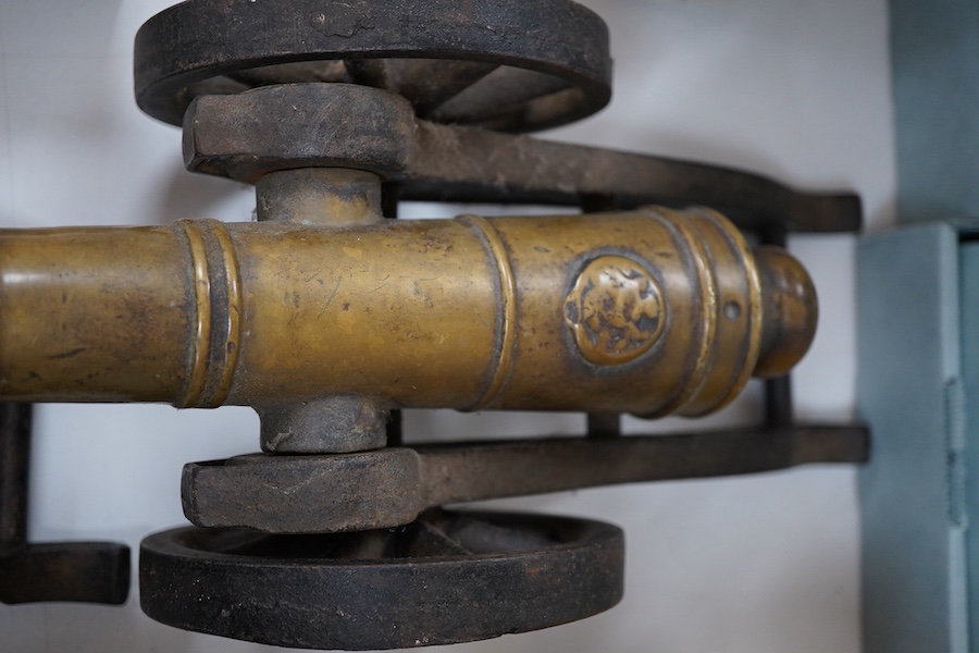 A pair of brass and cast iron model cannons, 34cm in length